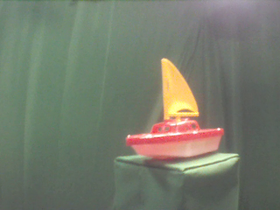 45 Degrees _ Picture 9 _ Red and Yellow Toy Sailboat.png